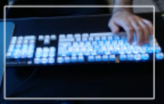 Live camera feed with a white boundary rectangle framing a backlit keyboard and a hand above it